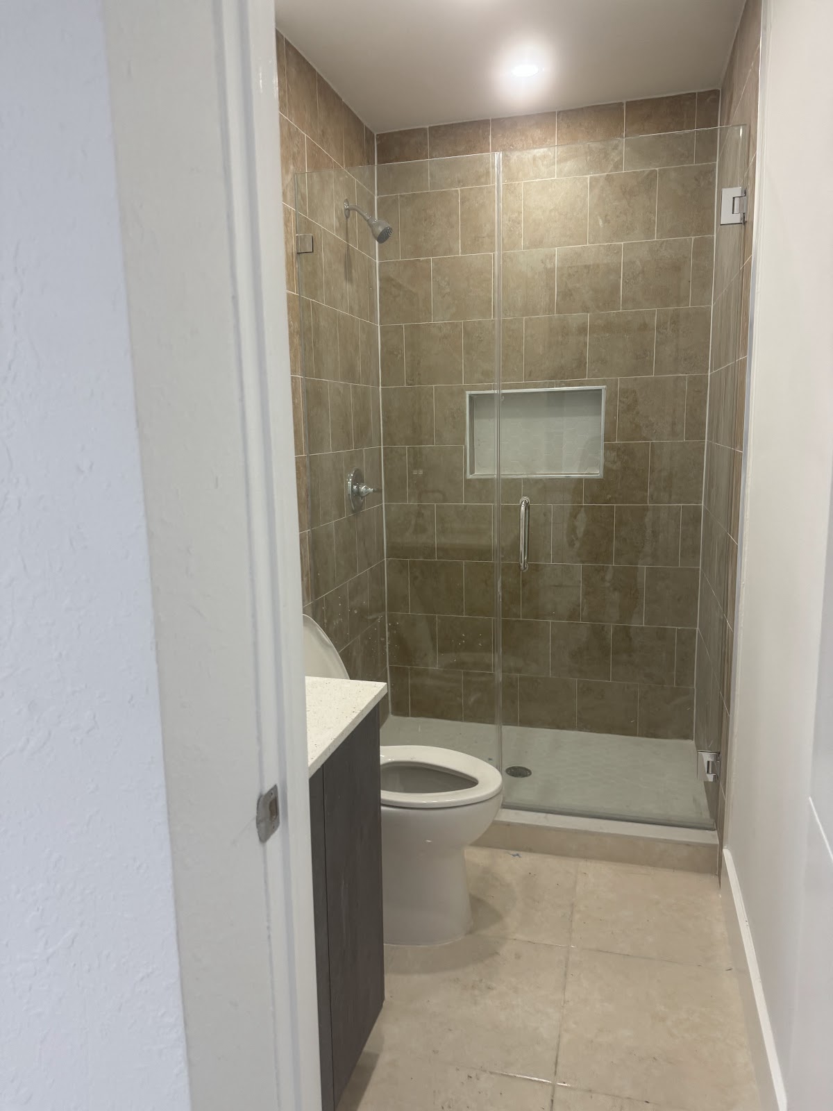 Bathroom remodel with tiled shower and glass door