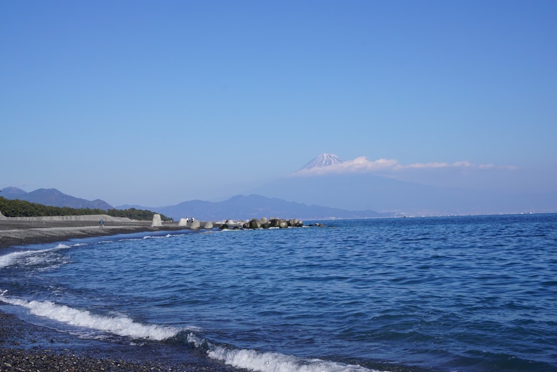 Waves on the black-sand beach at Miho with Mt. Fuji across Suruga Bay