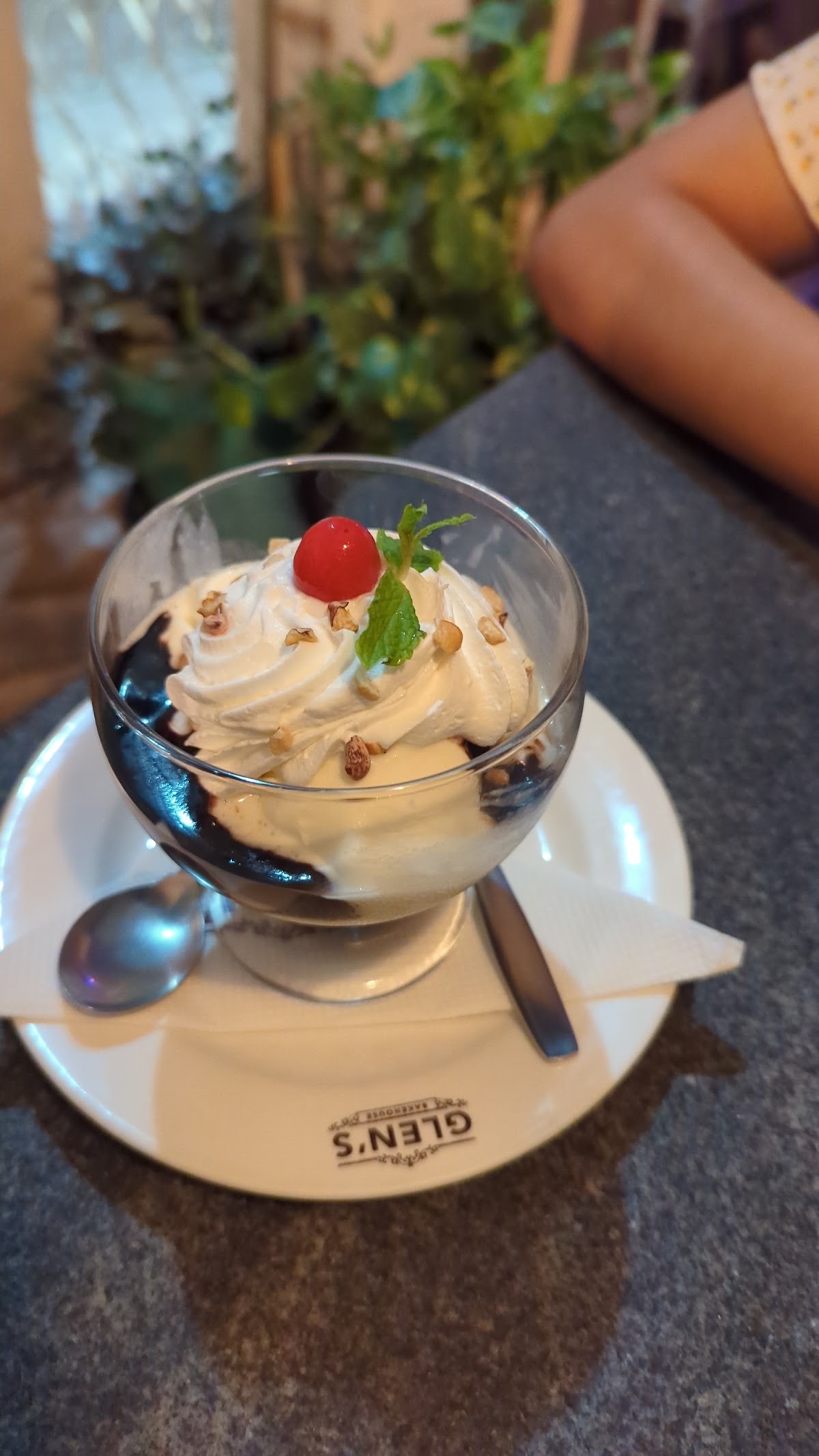 Glen's Bakehouse's delightful Sundae topped with a cherry and mint, showcasing their commitment to delectable desserts.