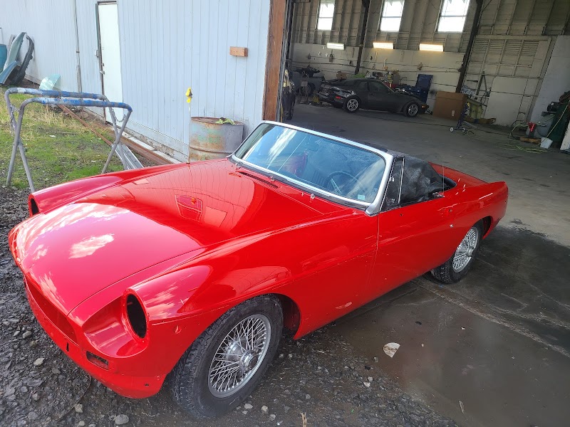Door and quarter panel repair in progress, showing structural work on collision damage.