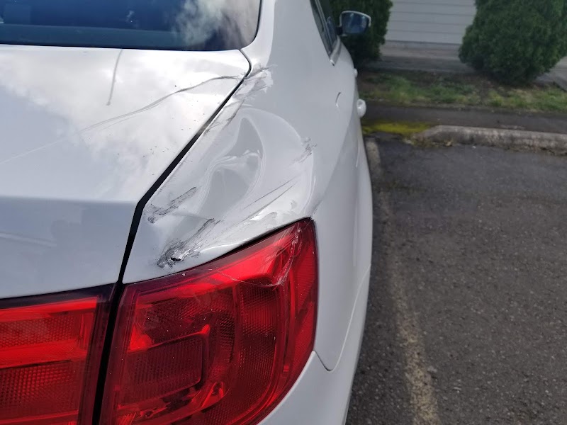 Luxury vehicle restoration in progress—meticulous work on high-end cars.
