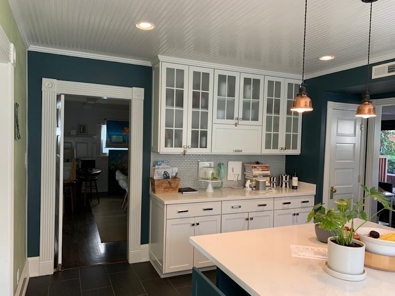 Before and after of exterior house painting with scraped, sanded, and primed surfaces ready for finish coat.