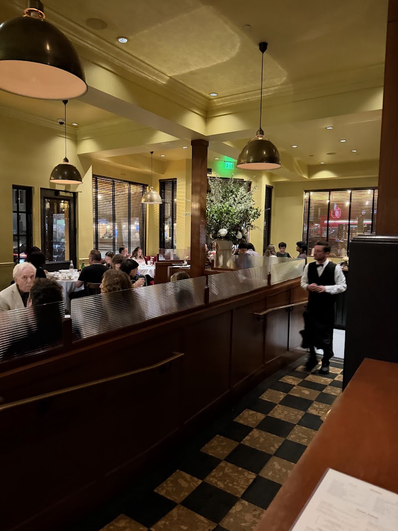 Classic old-school Italian interior with plush red booths and dark wood paneling