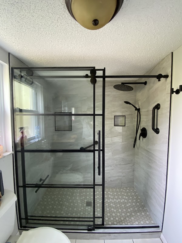 Modern shower renovation with glass enclosure and marble tile