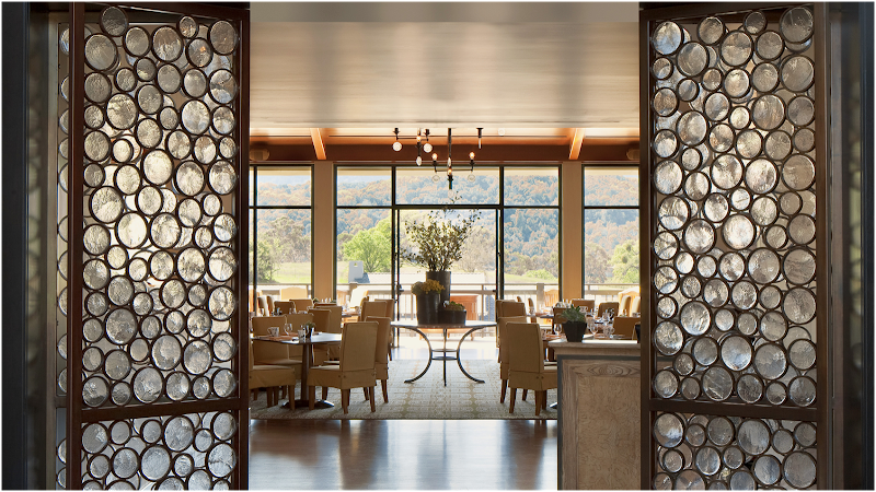 Handsome dining room with mountain views and a wall of windows