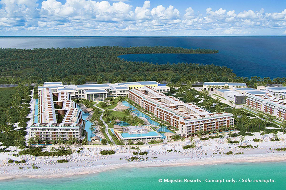 Aerial view of Majestic Mirage Costa Mujeres beachfront resort with multiple terracotta buildings, pools, and white sand beach facing turquoise water.