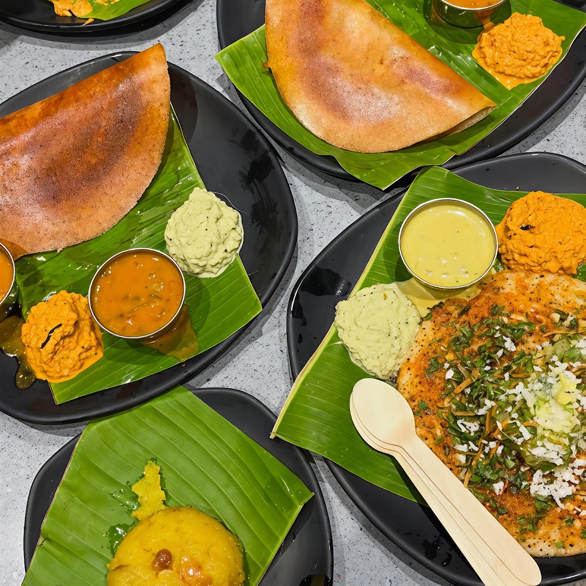 The Rameshwaram Cafe - Indiranagar's vibrant South Indian spread featuring crispy dosas and delectable chutneys, celebrating traditional flavors with a modern touch.