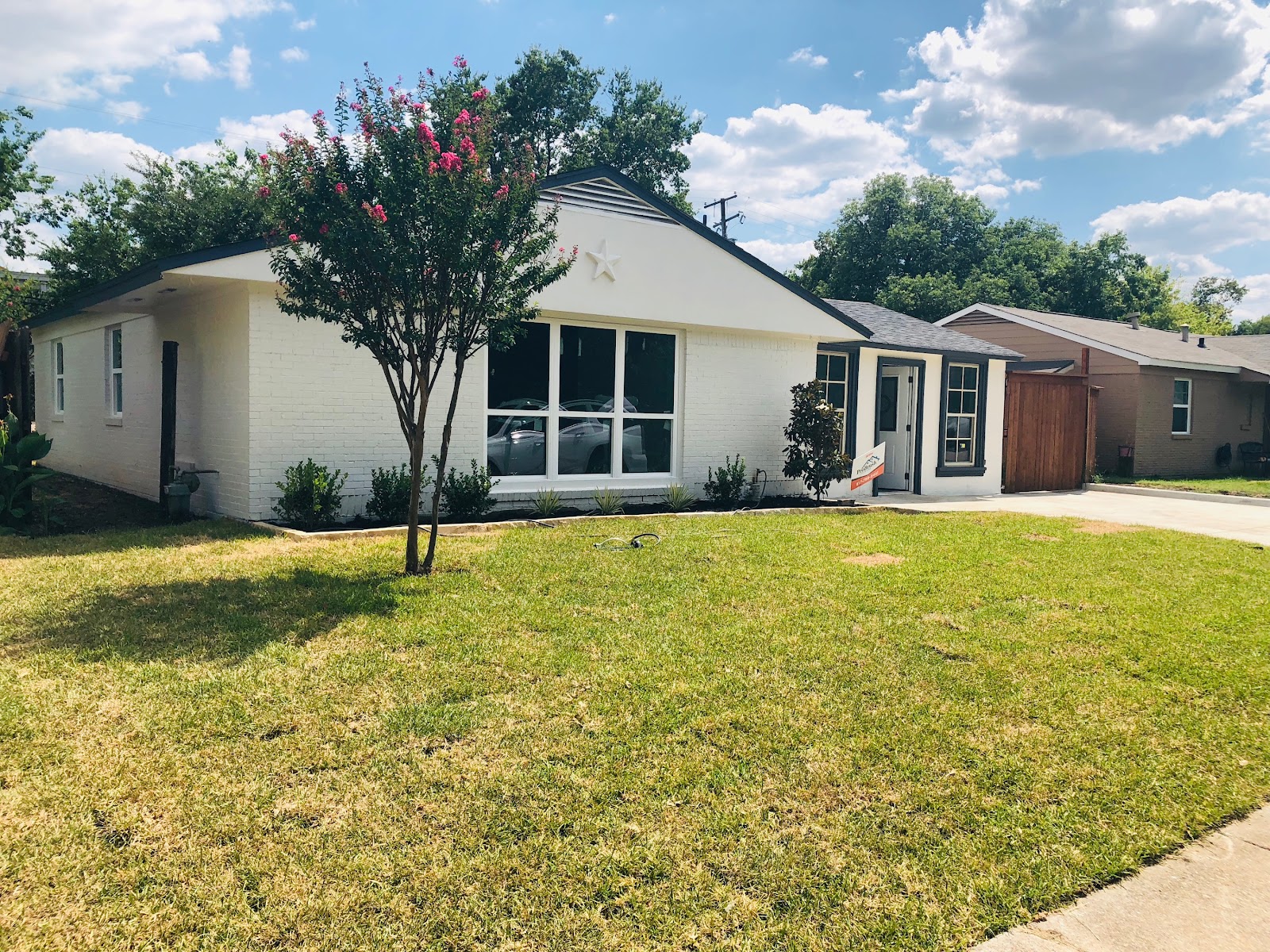 Freshly painted white brick exterior home by Pro Brush Painting