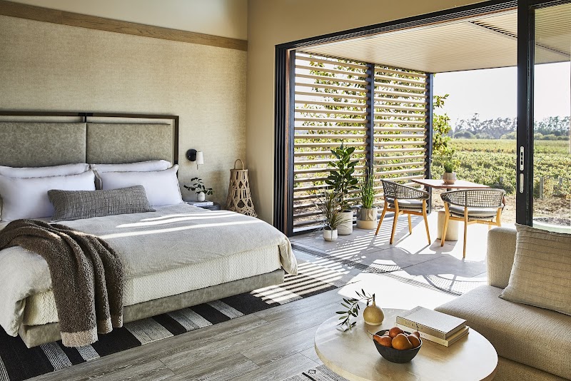 Natural indoor-outdoor accommodations with vineyard views